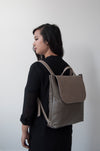 front view of the large ray backpack in taupe pebbled leather with veg tan flap