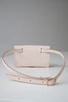 Front view of the Glare Sling in beige veg tan leather