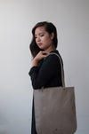 front view of the emit tote in taupe leather